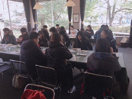 A group of people sitting at tables Description automatically generated